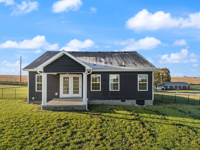 rear view of house featuring a yard, a patio, and french doors