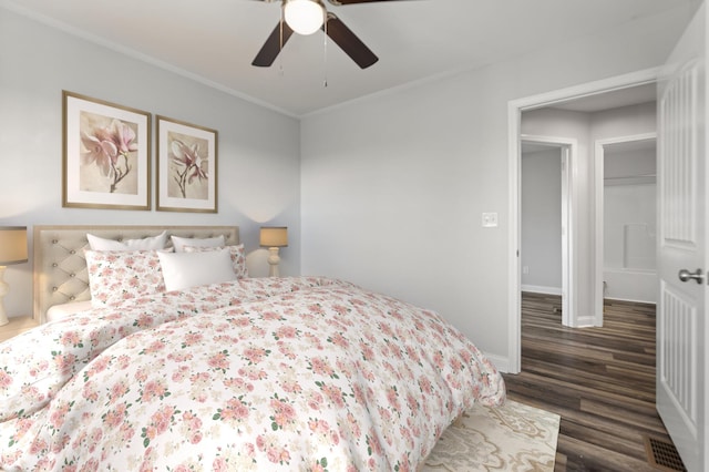 bedroom with dark hardwood / wood-style flooring, ornamental molding, and ceiling fan