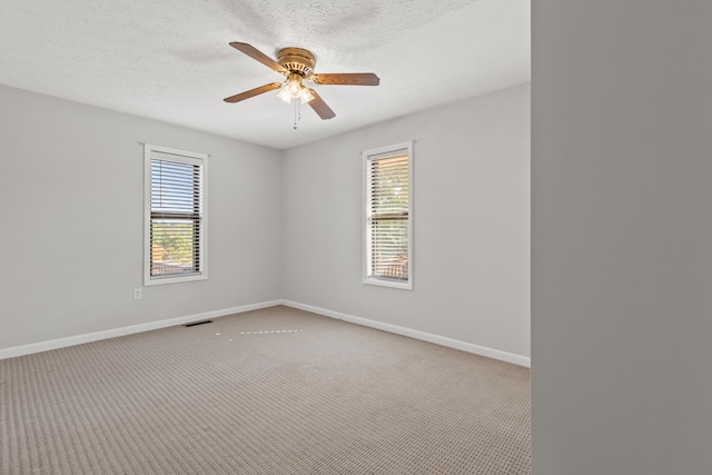 spare room with light carpet, a textured ceiling, and ceiling fan