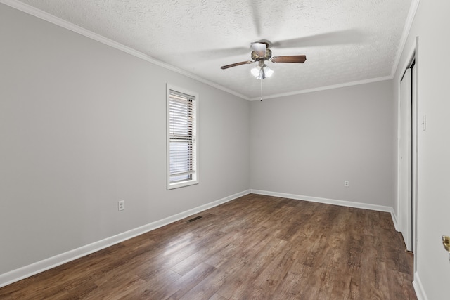 unfurnished bedroom with dark wood-type flooring, ceiling fan, crown molding, and a textured ceiling