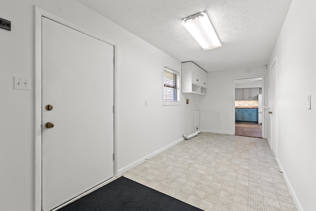 corridor with a textured ceiling