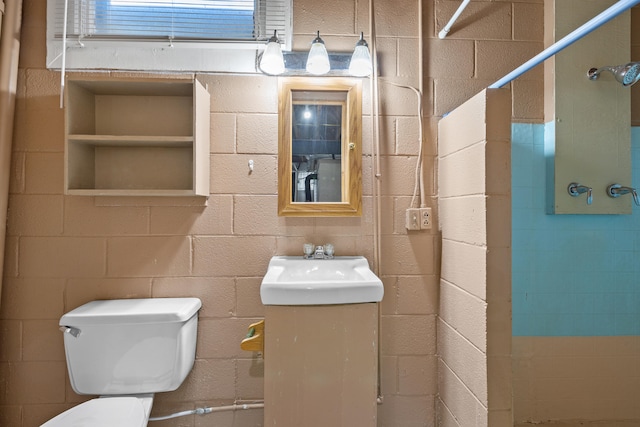 bathroom featuring toilet, walk in shower, and sink