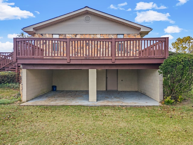 rear view of property with a wooden deck, a yard, and a patio