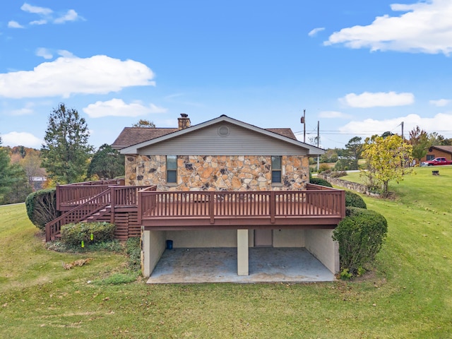 rear view of house featuring a wooden deck and a lawn