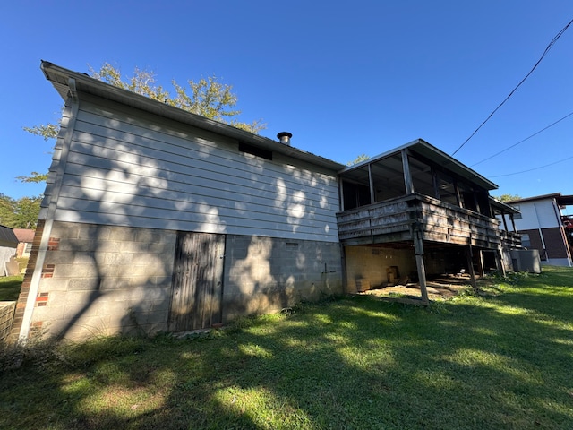 rear view of property featuring a lawn