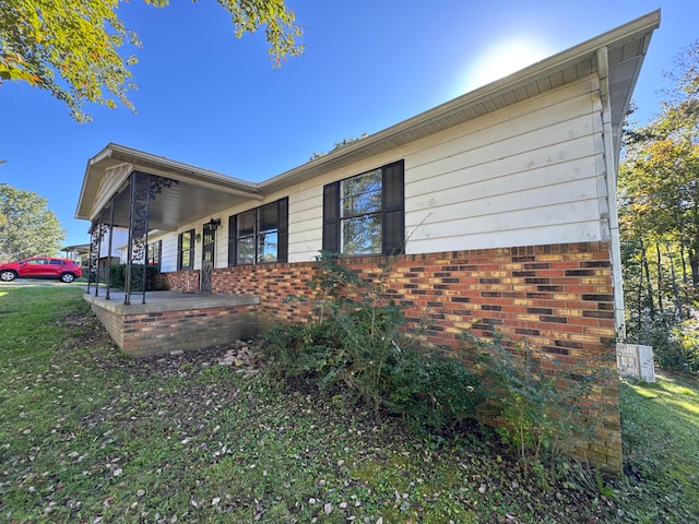 view of property exterior featuring a lawn