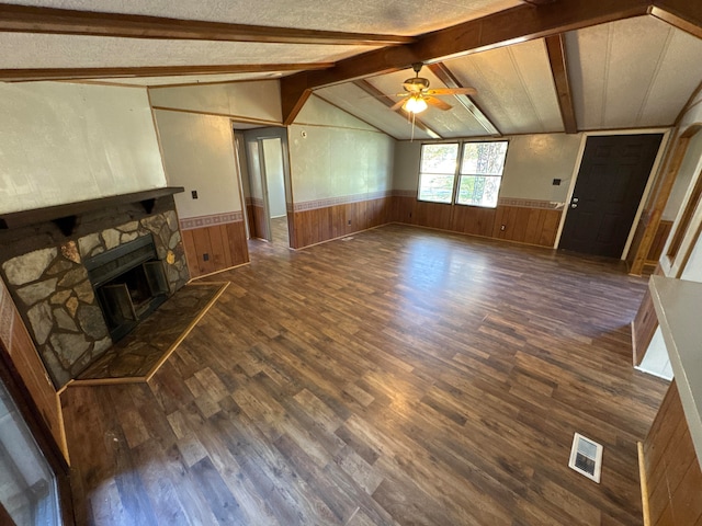 unfurnished living room featuring dark hardwood / wood-style floors, a textured ceiling, and a fireplace