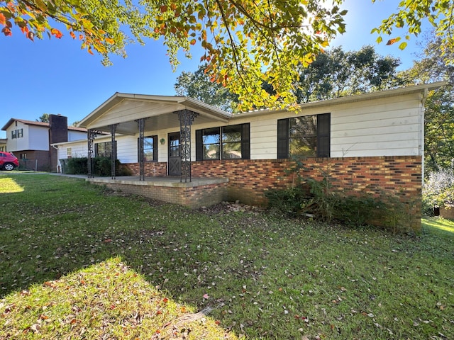 view of front of home with covered porch and a front yard