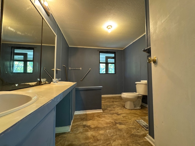 bathroom featuring vanity, ornamental molding, a textured ceiling, and toilet