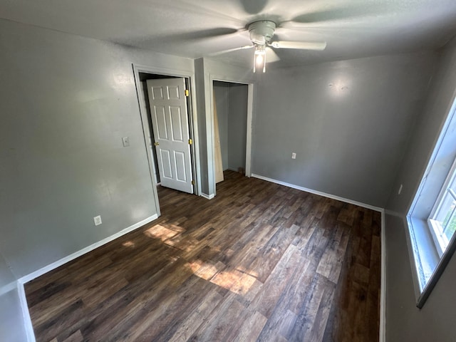 unfurnished bedroom with dark hardwood / wood-style floors and ceiling fan