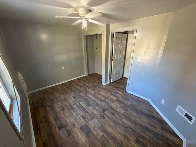 spare room featuring ceiling fan and dark hardwood / wood-style flooring