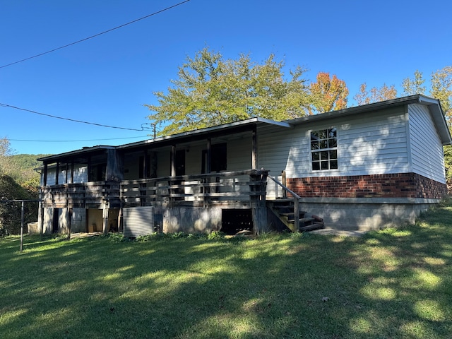 view of side of home with a lawn