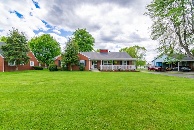 single story home with a porch and a front lawn