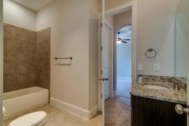 full bathroom with tile patterned floors, toilet, tiled shower / bath, vanity, and ceiling fan