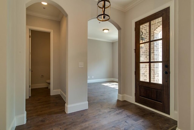 foyer featuring ornamental molding and dark hardwood / wood-style floors