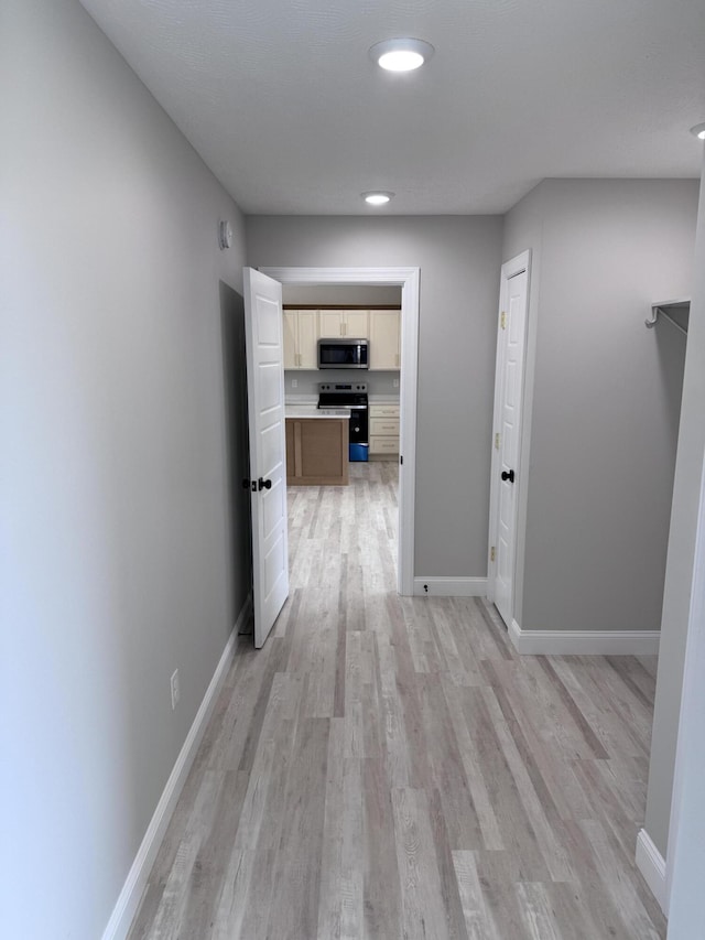 corridor with light wood-type flooring