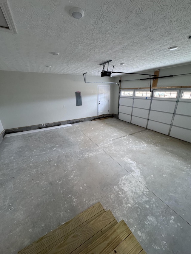 garage with a garage door opener and electric panel