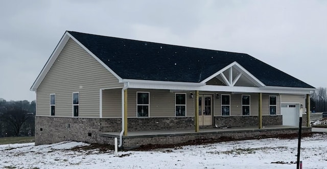 view of front of property with a porch and a garage