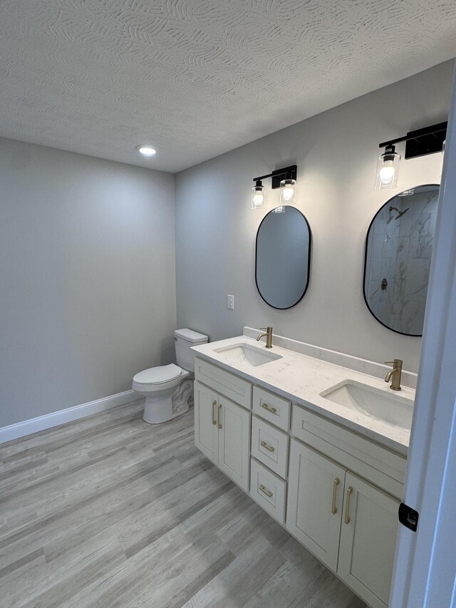 bathroom featuring hardwood / wood-style floors and a textured ceiling