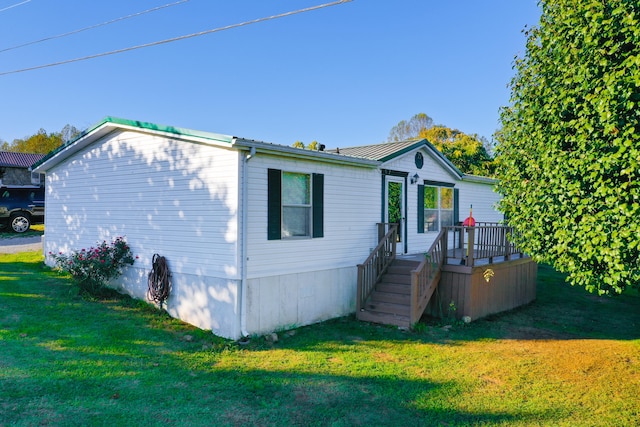 exterior space with a deck and a front lawn