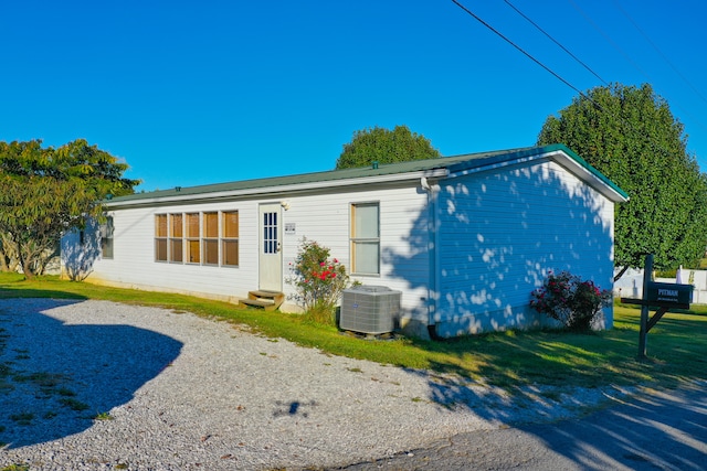 back of property with a yard and cooling unit