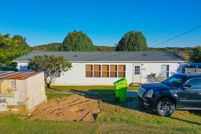 rear view of property with a lawn