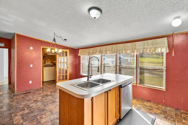 kitchen featuring sink, a textured ceiling, hanging light fixtures, stainless steel dishwasher, and crown molding