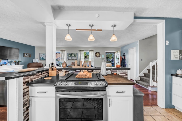 kitchen with white cabinetry, stainless steel range with electric stovetop, and a textured ceiling