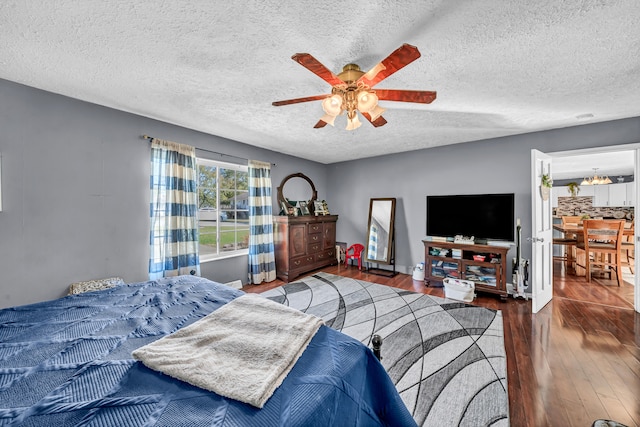 bedroom featuring ceiling fan, a textured ceiling, and dark hardwood / wood-style floors