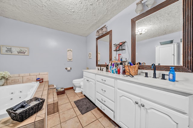 bathroom with vanity, a textured ceiling, a tub to relax in, and tile patterned flooring