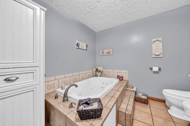 bathroom featuring a textured ceiling, tiled tub, toilet, and tile patterned flooring