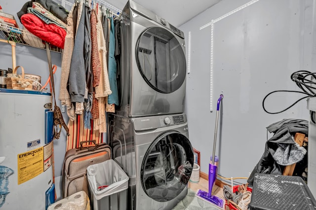 laundry room featuring electric water heater and stacked washer and clothes dryer