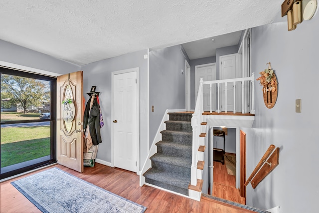 foyer featuring a textured ceiling and wood-type flooring