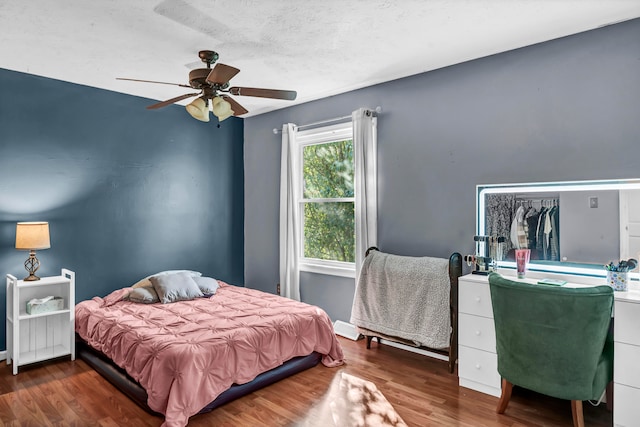 bedroom with ceiling fan and dark hardwood / wood-style floors