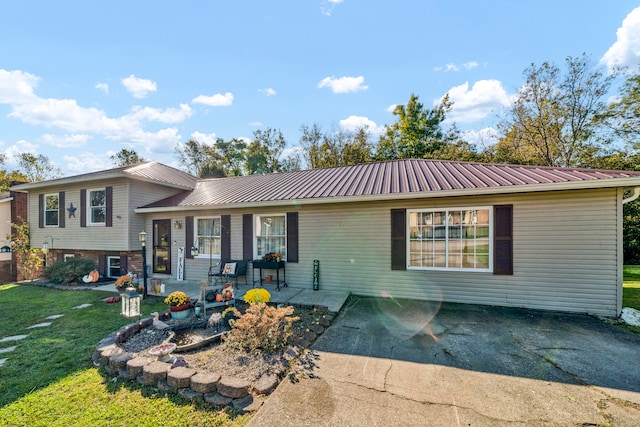 view of front of property with a patio area and a front lawn