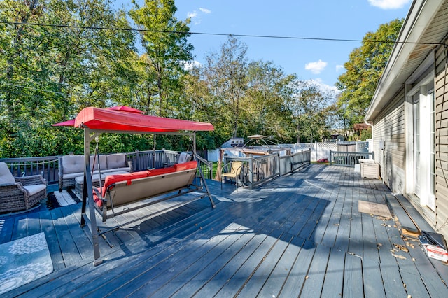 wooden terrace with an outdoor hangout area