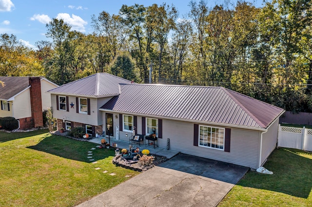 view of front facade with a front lawn and a patio