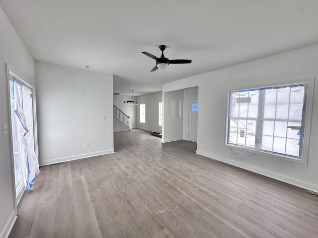 unfurnished living room with ceiling fan and light wood-type flooring