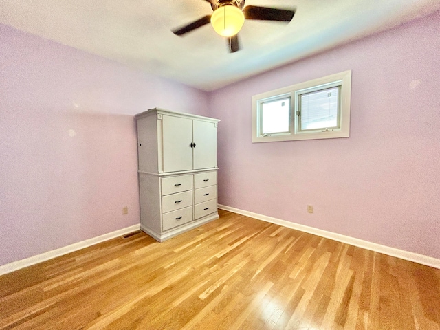 unfurnished bedroom featuring light wood-type flooring and ceiling fan