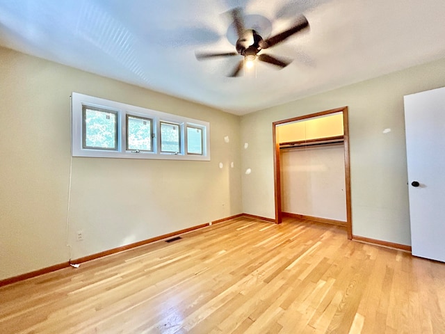 unfurnished bedroom with a closet, light hardwood / wood-style floors, and ceiling fan