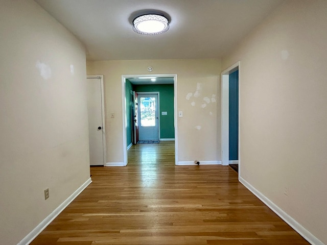 hallway with light hardwood / wood-style flooring