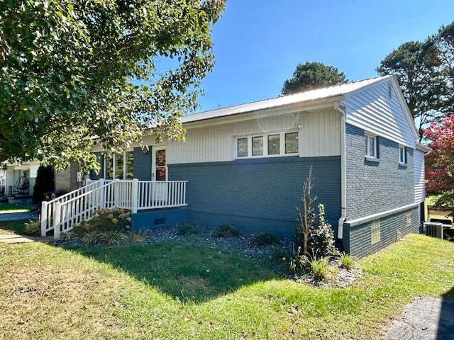 view of home's exterior featuring central air condition unit and a lawn