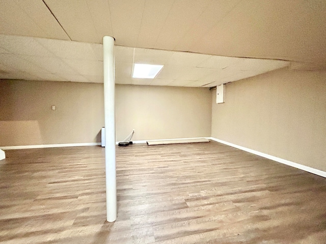 basement with hardwood / wood-style floors