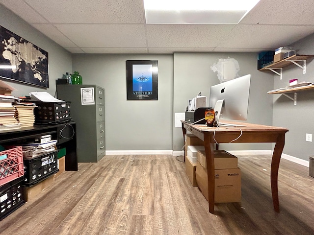 office with wood-type flooring and a drop ceiling