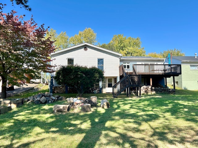 rear view of house with a deck and a lawn