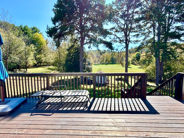 wooden deck featuring a yard