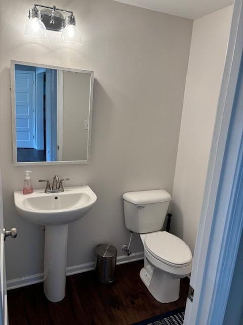 bathroom with toilet and hardwood / wood-style flooring