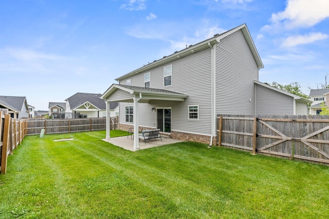 back of property with a patio area and a lawn