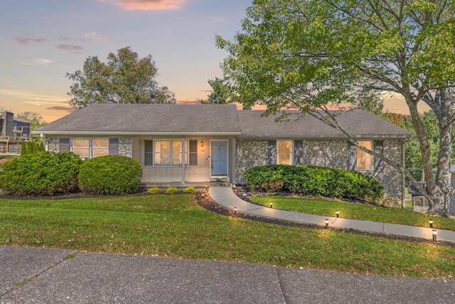 single story home featuring a yard