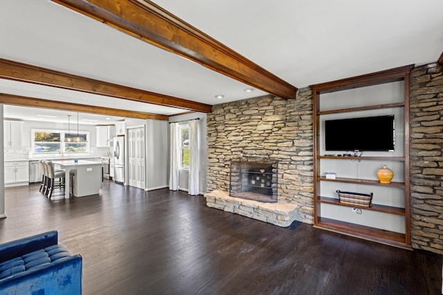 living room featuring beam ceiling, dark hardwood / wood-style flooring, and a fireplace